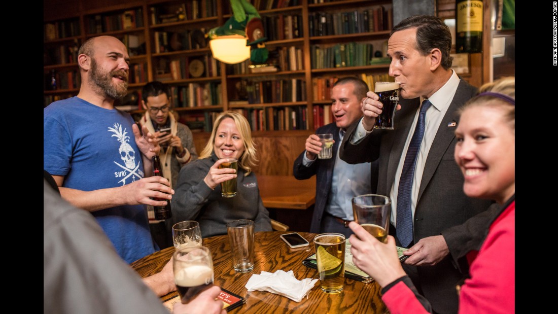 Republican presidential candidate Rick Santorum, second from right, drinks a beer at a pub in Waukee, Iowa, on January 28, 2016. The former U.S. senator from Pennsylvania also ran in 2012.