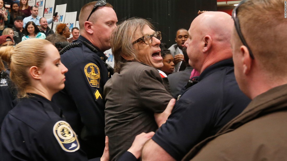 Christopher Morris, a photographer on assignment for Time magazine, is escorted by police during a Trump rally in Radford, Virginia, on February 29, 2016. Morris said a Secret Service agent choked him and slammed him to the ground as he tried to leave a media pen at the event. &lt;a href=&quot;http://www.cnn.com/2016/02/29/politics/donald-trump-event-protest-rally/&quot; target=&quot;_blank&quot;&gt;The incident was caught on video.&lt;/a&gt;