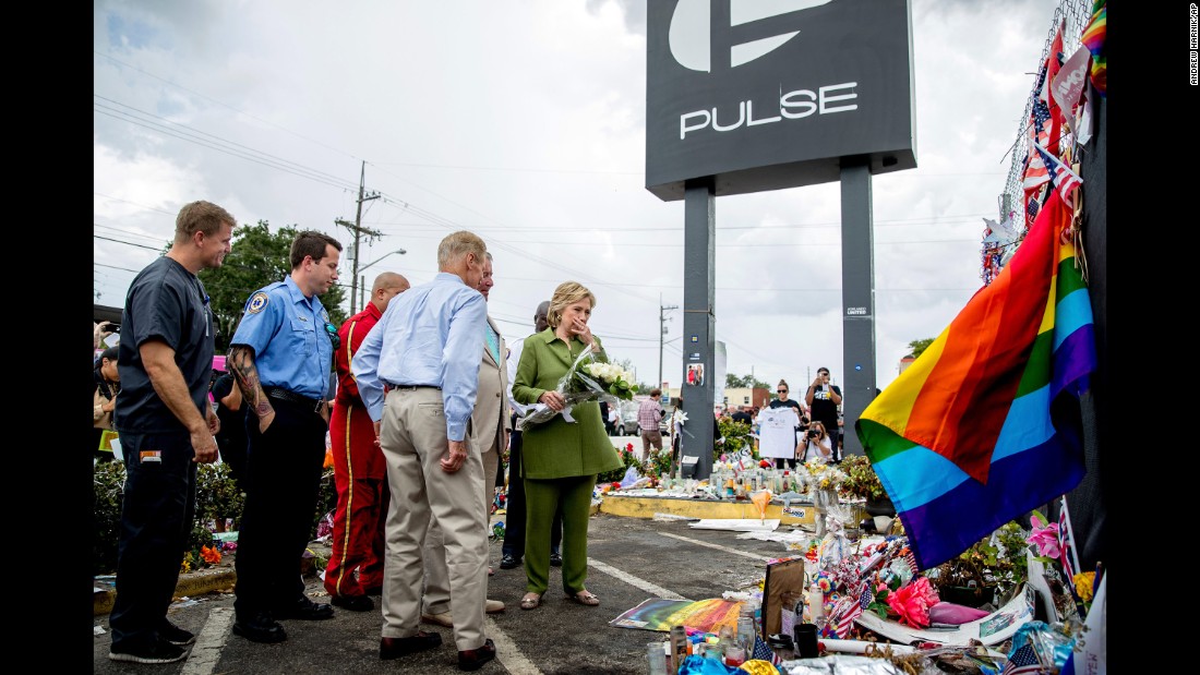 Clinton, accompanied by first responders and U.S. Sen. Bill Nelson, visits a memorial outside of the Pulse nightclub in Orlando on July 22, 2016. The nightclub was the site of a June shooting that killed 49 people.