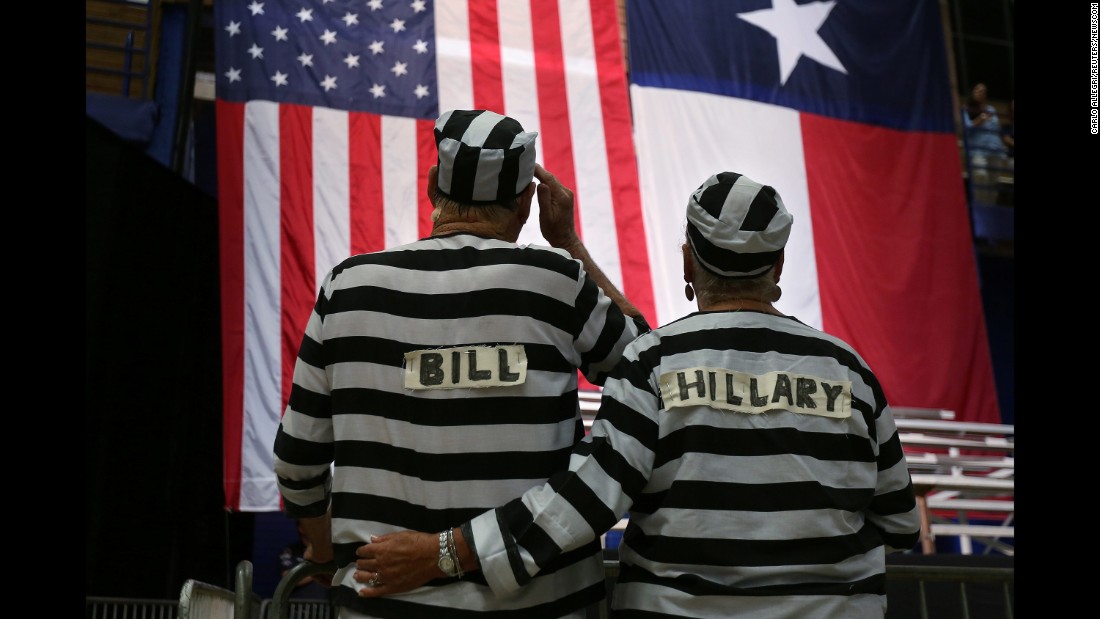 Trump supporters wear prison costumes with the Clintons&#39; names on them at a campaign rally in Austin, Texas, on August 23, 2016.