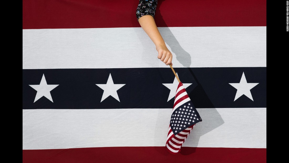 A Clinton supporter waves a flag during a campaign event in Reno, Nevada, on August 25, 2016.