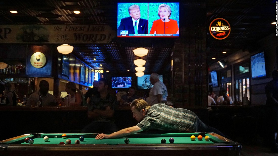 The &lt;a href=&quot;http://www.cnn.com/2016/09/26/politics/gallery/first-presidential-debate/index.html&quot; target=&quot;_blank&quot;&gt;first debate between Trump and Clinton&lt;/a&gt; is seen on television at a bar in San Diego on September 26, 2016.