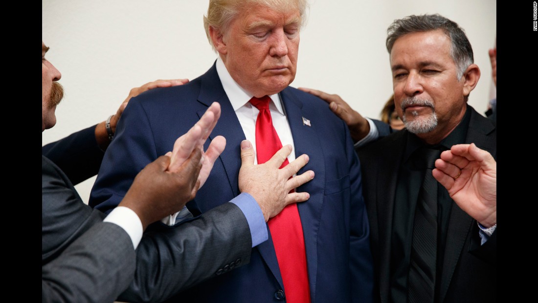 Pastors pray with Trump during the Republican nominee&#39;s visit to Las Vegas on October 5, 2016.