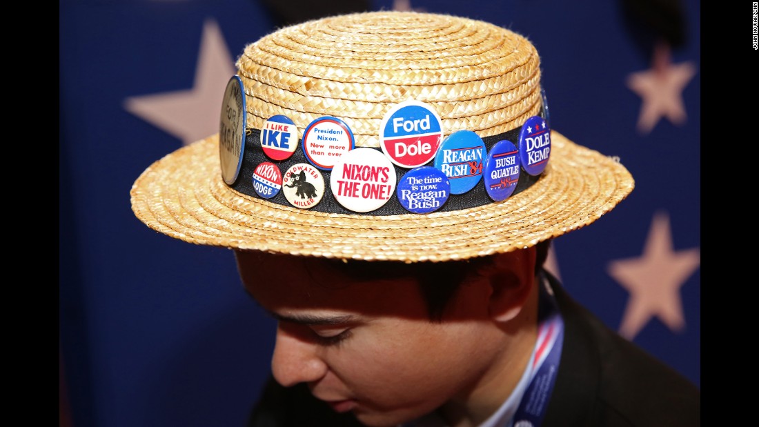 A Republican&#39;s hat carries old campaign buttons at the convention in Cleveland.