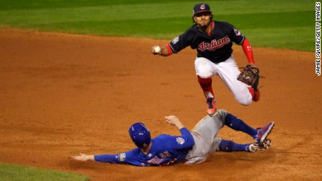 Francisco Lindor of the Cleveland Indians jumps over Chris Coghlan of the Chicago Cubs in the ninth inning in Game 7.