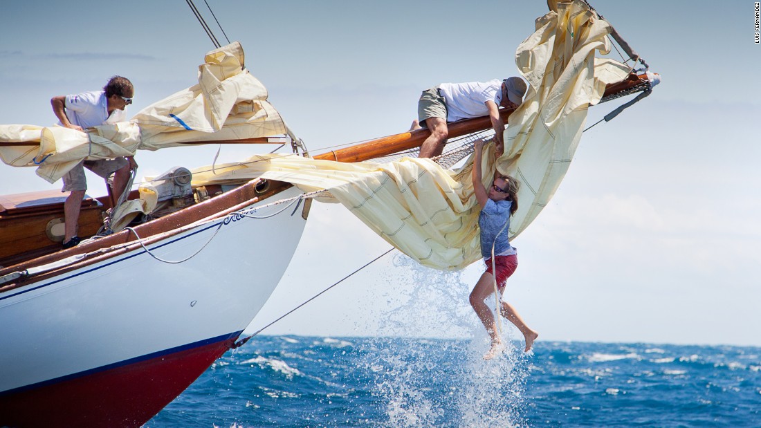 The bow woman of the yacht Gipsy loses her balance following a wave but is able to climb back on board thanks to a crew member during the Puig Vela Classica Barcelona. Luis Fernandez captured the action.