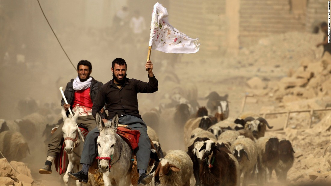 A man fleeing the village of Bazwaya carries a white flag as he arrives at a checkpoint on November 1.