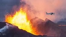 An aerial picture taken on September 14, 2014 shows a plane flying over the Bardarbunga volcano spewing lava and smoke in southeast Iceland. The Bardarbunga volcano system has been rocked by hundreds of tremors daily since mid-August, prompting fears the volcano could explode. Bardarbunga, at 2,000 metres (6,500 feet), is Iceland's second-highest peak and is located under Europe's largest glacier, Vatnajoekull. AFP PHOTO /  BERNARD MERIC        (Photo credit should read BERNARD MERIC/AFP/Getty Images)