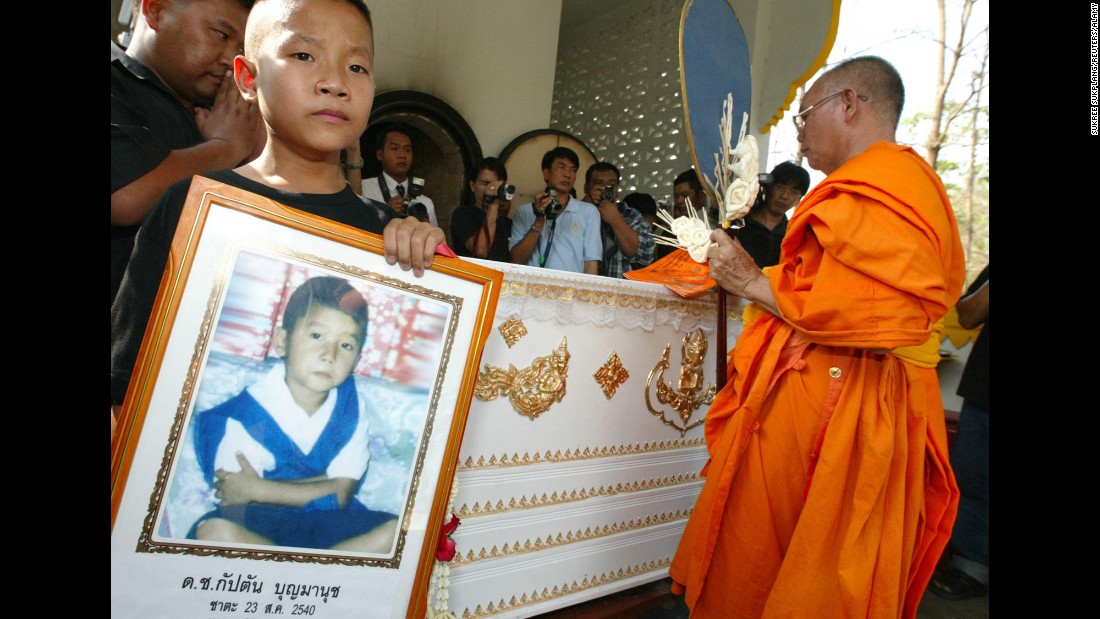 Captain Boonmanuch, a young boy who lived in northern Thailand, may have played a small role in the spread of H5N1 avian flu, or bird flu, in 2003. He was the first human death from bird flu in Thailand during the outbreak. Patipahat Boonmanuch, Captain&#39;s brother, held a picture of him during his funeral.