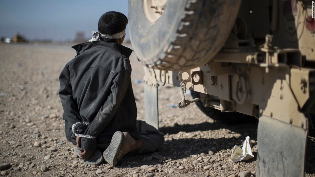 A suspected member of ISIS is detained at a checkpoint near Bartella, Iraq, on November 4.