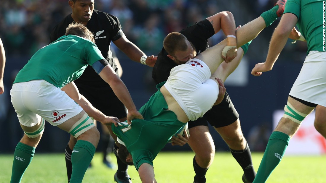 Robbie Henshaw of Ireland is upended by Joe Moody of New Zealand during the international match between Ireland and New Zealand at Soldier Field. 