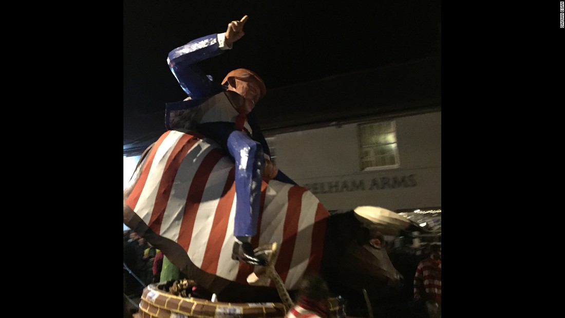 An effigy of Trump riding a bucking bull draped in the Stars and Stripes is paraded down the street in Lewes on November 5.