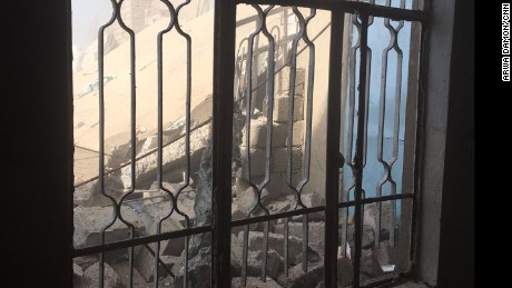 Rubble is seen through a window. An airstrike took out the house behind the one in which Arwa and Brice were staying.