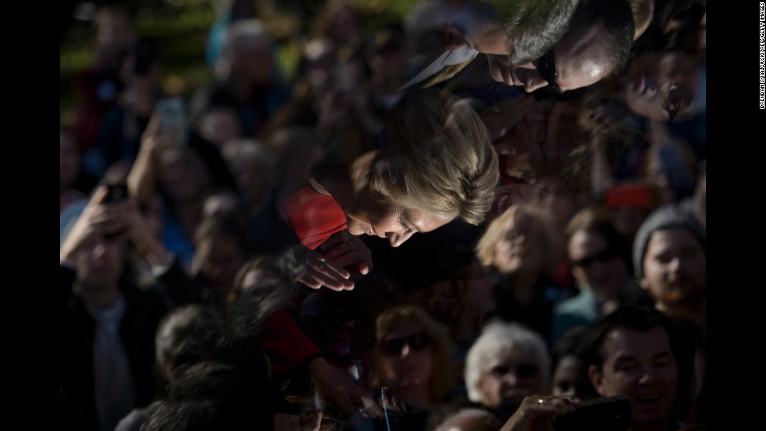 Clinton&#39;s image is reflected in a teleprompter as she greets supporters after a rally in Pittsburgh on November 7.