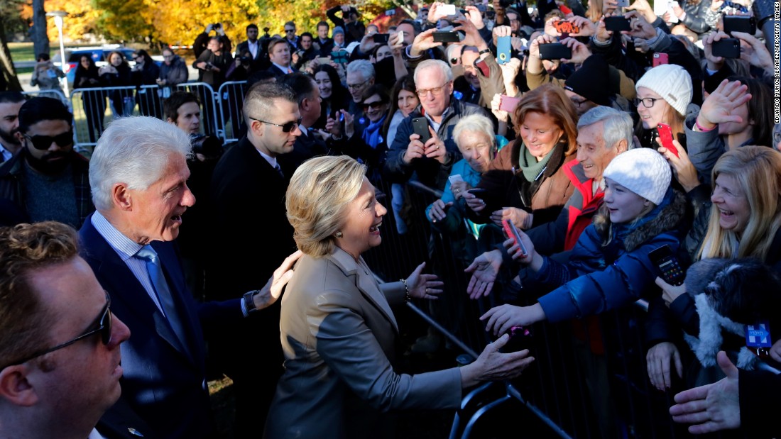 Democratic presidential nominee Hillary Clinton and her husband, former U.S. President Bill Clinton, greet supporters after voting in Chappaqua, New York.