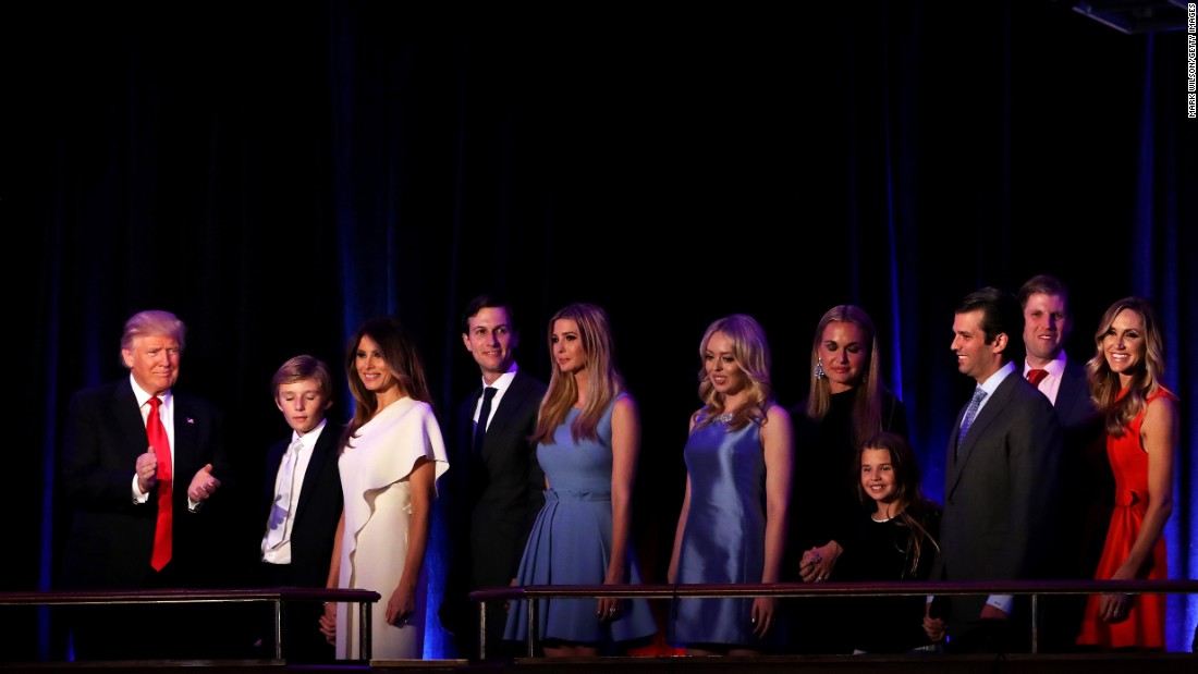 Trump, on stage with his family, acknowledges the crowd at the New York Hilton Midtown Hotel. He was gracious toward his opponent, Hillary Clinton, and called for unity. &quot;We owe (Clinton) a very major debt of gratitude to her for her service to our country,&quot; Trump said. &quot;I say it is time for us to come together as one united people.&quot;