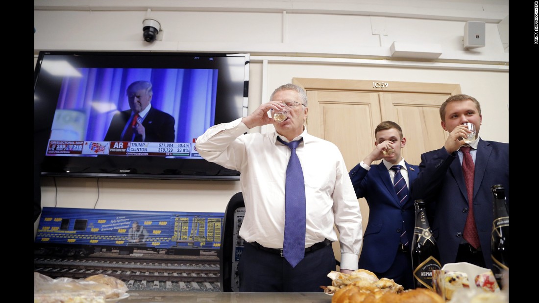 Vladimir Zhirinovsky, leader of the Liberal Democratic Party of Russia, left, toasts in front of a TV screening Trump&#39;s acceptance speech on November 9.