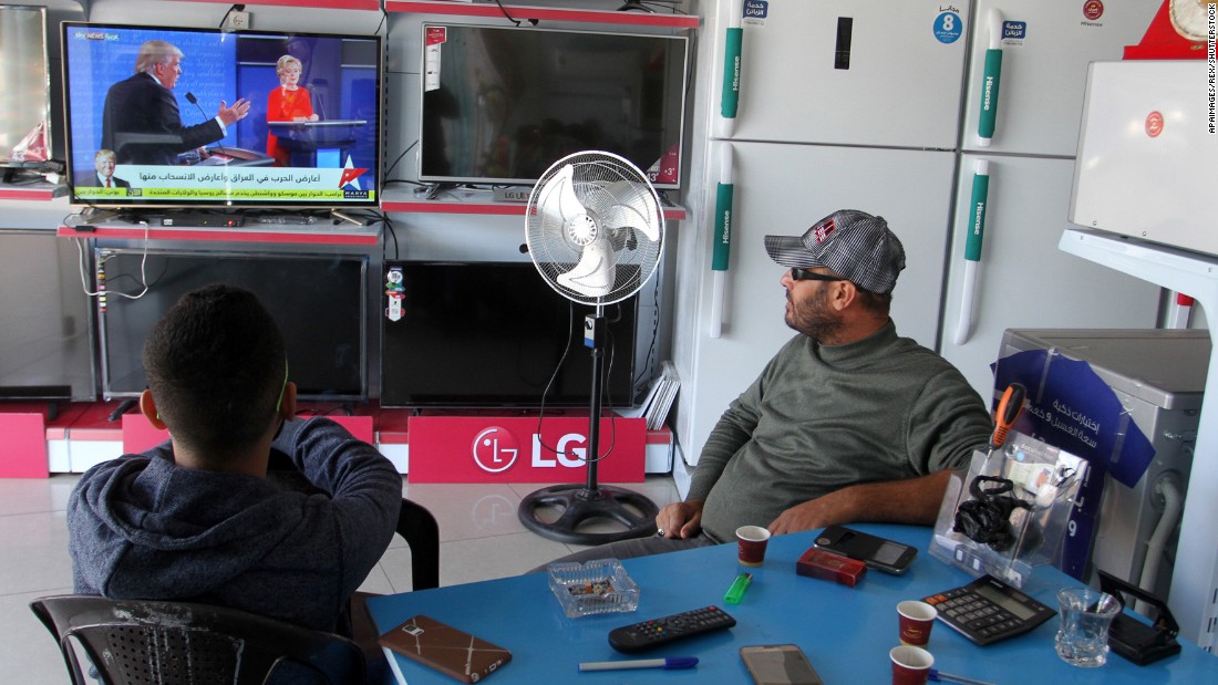 Two men in Gaza watch coverage of the election on November 9.