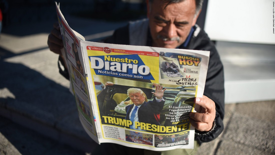 A man reads a newspaper proclaiming Trump&#39;s victory in Guatemala City, Guatemala, on November 9.