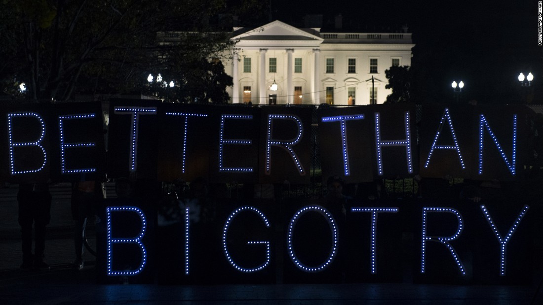 Protesters from Avaaz, a global civic movement, display a sign protesting bigotry outside the White House on Tuesday, November 8.