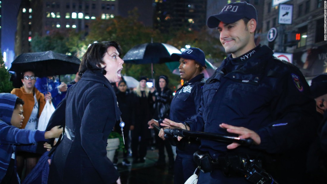 A woman argues with police officers during a protest in New York on November 9. Erin Michelle Threlfall, the woman pictured, told &lt;a href=&quot;http://www.huffingtonpost.com/entry/5824aa40e4b0270d9a2ad89e?timestamp=1478799395467&quot; target=&quot;_blank&quot;&gt;The Huffington Post &lt;/a&gt;she was attempting to intervene on behalf of a man she says the police were beating.