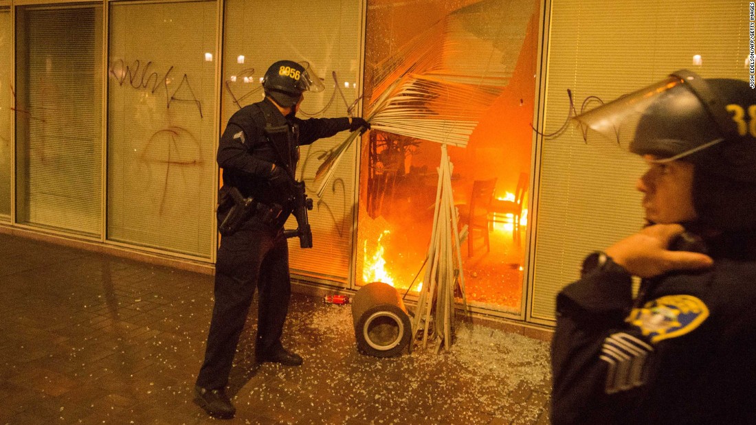 Police respond to a fire set by anti-Trump protesters in Oakland, California, on November 9. Police said some protesters threw Molotov cocktails, rocks and fireworks at officers.