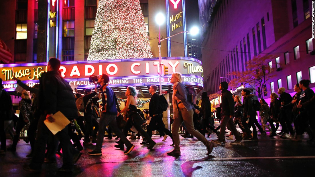 Demonstrators march past Radio City Music Hall in New York on November 9.