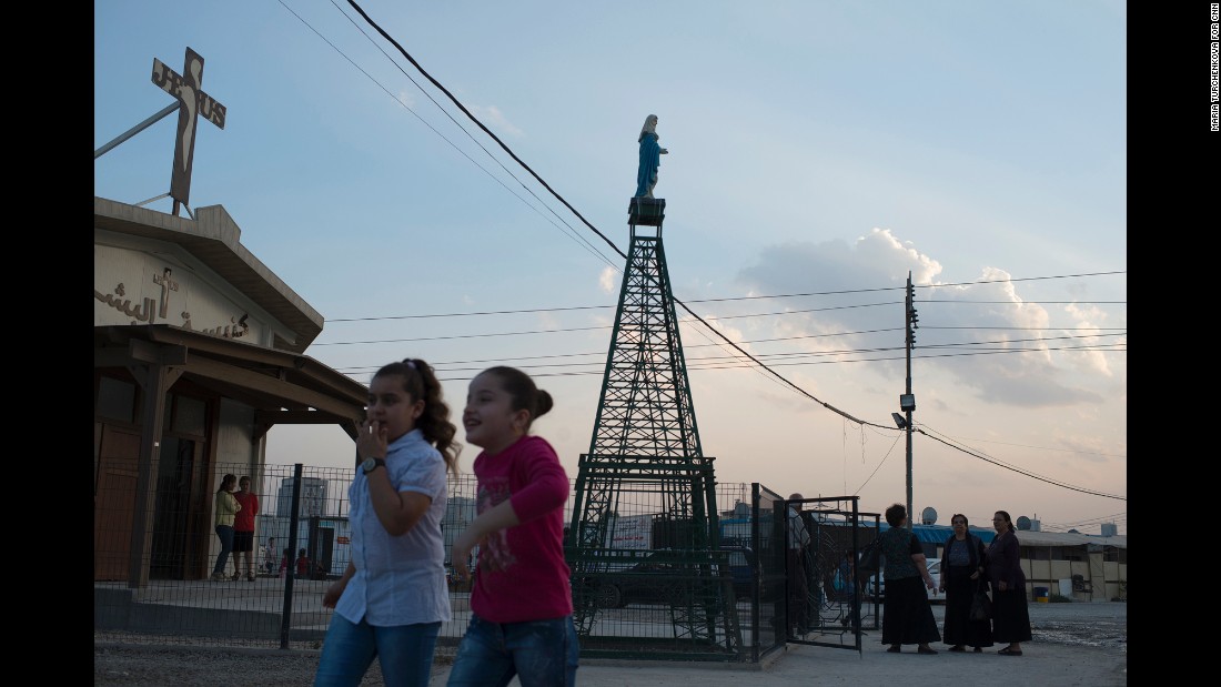 People gather for service at Ashti camp as the sun goes down on a Sunday evening. 