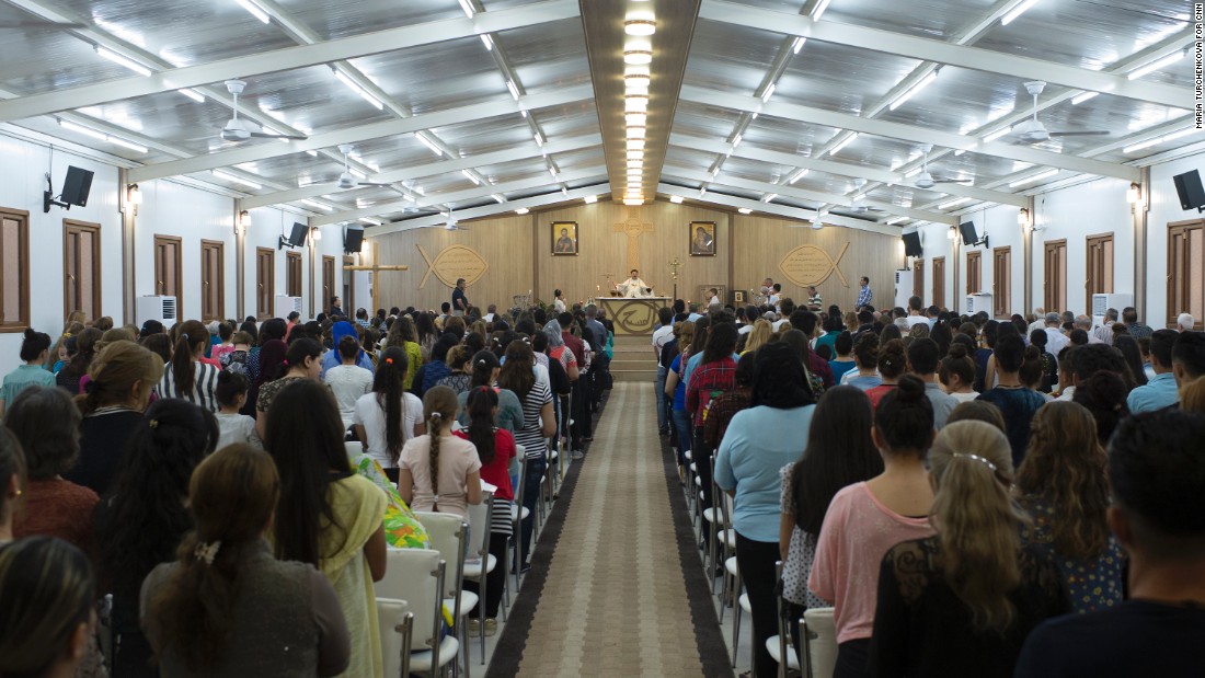 Iraqi Christians displaced from their homes for more than two years attend church on a Sunday evening at a camp in Irbil.