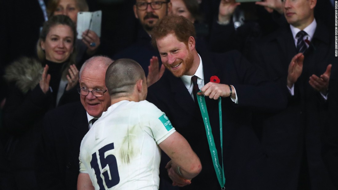 Prince Harry presents a winner&#39;s medal to Mike Brown of England.