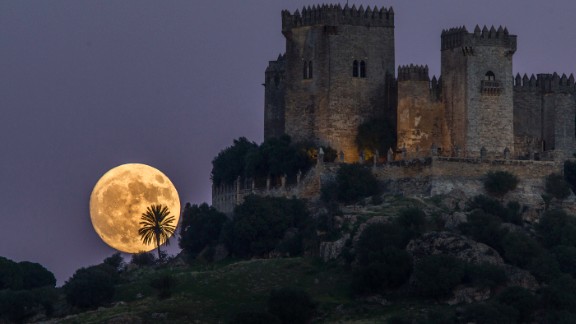 The moon rises behind the Almodovar castle in Cordoba, Spain, on Sunday, November 13.