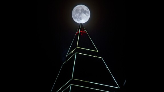 The supermoon appears behind the MesseTurm tower in Frankfurt, Germany, on November 13.