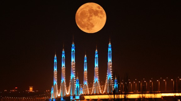 The moon appears over the Binhe Yellow River Bridge in Yinchuan, China, on November 14. 