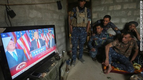 Members of the Iraqi forces watch Donald Trump giving a speech after he won the US president elections in the village of Arbid on the southern outskirts of Mosul on November 9, 2016, as they rest in a house during the ongoing military operation to retake Mosul from the Islamic State (IS) group. 