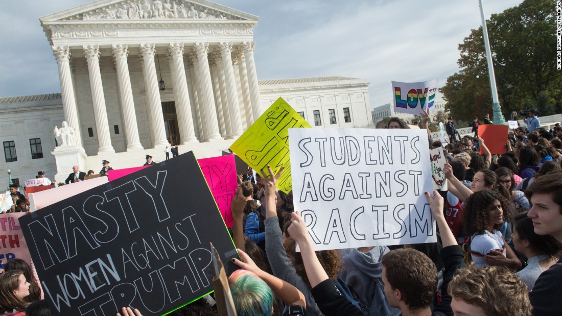 Students hold signs in front of the Supreme Court in Washington during a protest on Tuesday, November 15.