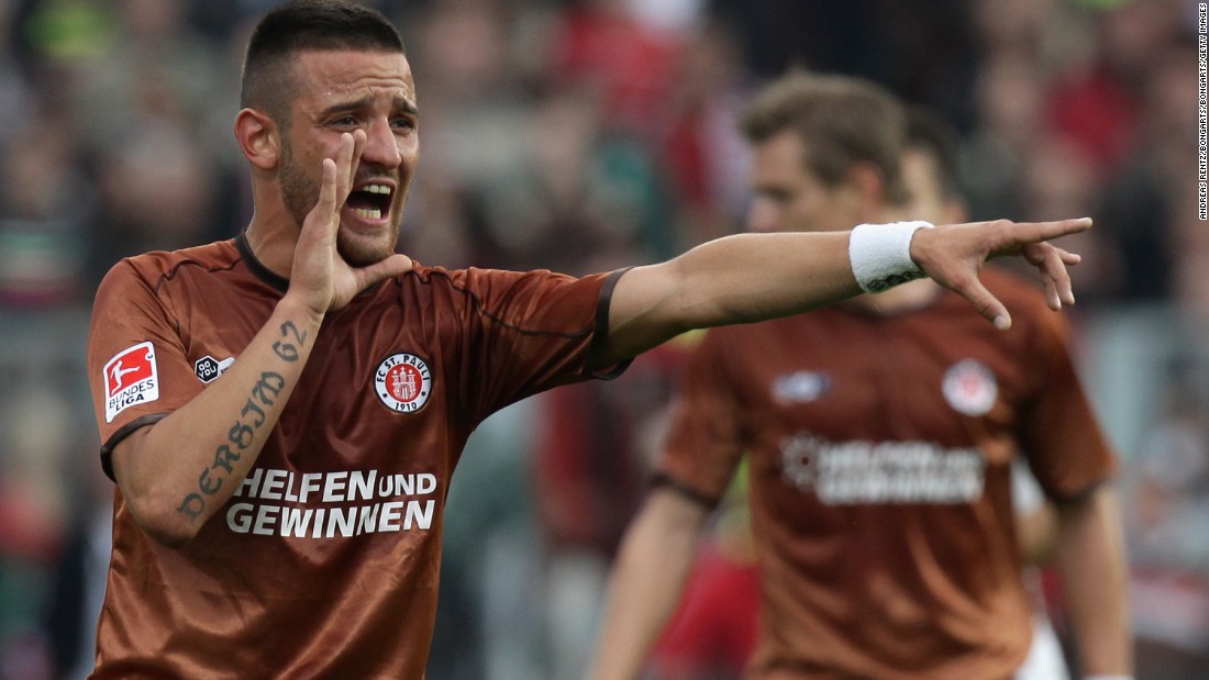 German footballer Deniz Naki -- shown playing for former club St. Pauli of the Bundesliga -- was banned for 12 matches and fined $5,825 for a Facebook post dedicating his Turkish second division club&#39;s victory to Kurdish combatants in southeastern Turkey. Naki&#39;s parents are of Kurdish origin, and he has Kurdish-themed tattoos on his arms. 