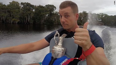 Open champion Henrik Stenson jet skiing in Florida with golf&#39;s famous Claret Jug.