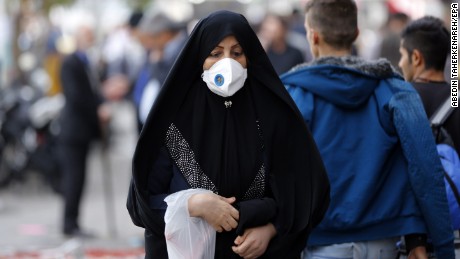 An Iranian woman wears mask as she walk in a street in Tehran on November 16, 2016.