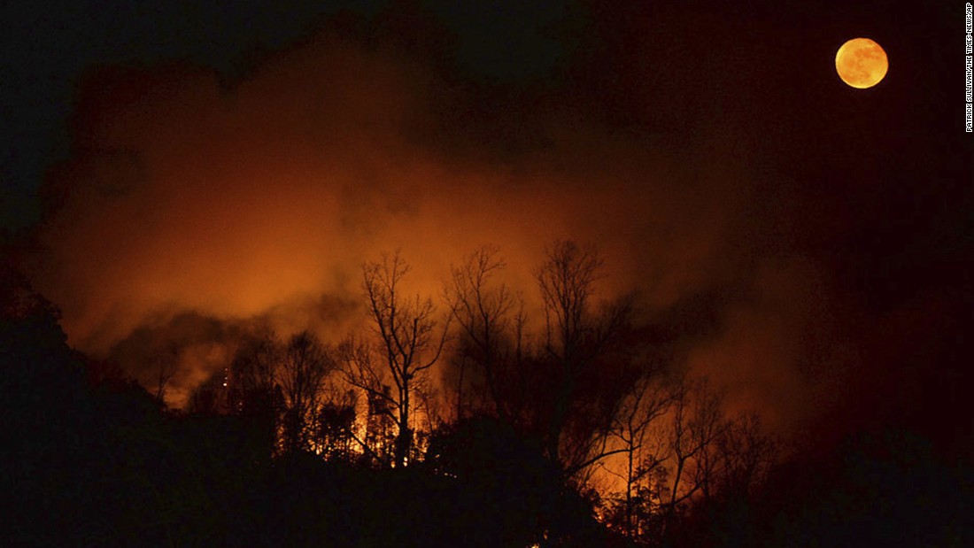 A wildfire burns as it approaches Bat Cave, North Carolina, on November 15.