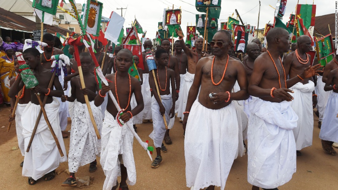 Royalist supporters dance and parade during the coronation ceremony of the new Oba.