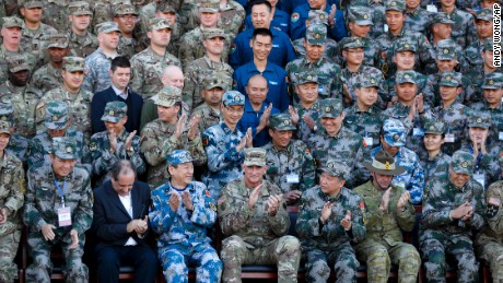 U.S. Army Pacific commander Gen. Robert Brown, front row center, and Gen. Liu Xiaowu, front row third right, the commander for Southern Theater Command Army of Chinese Liberation Army (PLA), applaud with their soldiers at a group photo session after conducting the U.S.-China Disaster Management Exchange (DME) drill at a PLA&#39;s training base in Kunming in southwest China&#39;s Yunnan province, Friday, Nov. 18, 2016. Chinese and U.S. troops staged joint drills Friday in an effort to better coordinate a response to humanitarian disasters and build confidence between their militaries that remain deeply wary of each other. (AP Photo/Andy Wong)