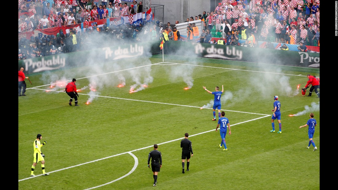 Flares, thrown onto the field from the stands, &lt;a href=&quot;http://www.cnn.com/2016/06/17/football/gallery/euro-2016-day-8/index.html&quot; target=&quot;_blank&quot;&gt;interrupt the Euro 2016 match&lt;/a&gt; between Croatia and the Czech Republic on Friday, June 17. 