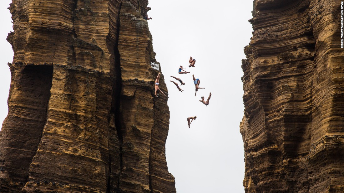 Divers jump off a 72-foot monolith in Portugal&#39;s Azores region before a Cliff Diving World Series event on Thursday, July 7.
