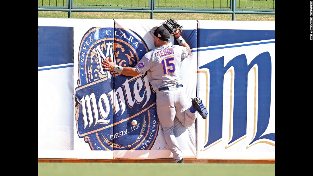 Tim Tebow crashes into the outfield wall as he tries to catch a fly ball during a minor-league baseball game in Glendale, Arizona, on Tuesday, October 11. The former Heisman Trophy winner, who last played in the NFL in 2012, &lt;a href=&quot;http://www.cnn.com/2015/05/08/opinions/coy-wire-tim-tebow-chases-dream/&quot; target=&quot;_blank&quot;&gt;is now giving pro baseball a shot.&lt;/a&gt;
