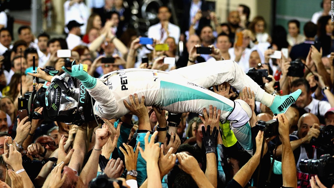 Nico Rosberg savors the moment of victory with his Mercedes team after clinching the world title in Abu Dhabi on Sunday. 