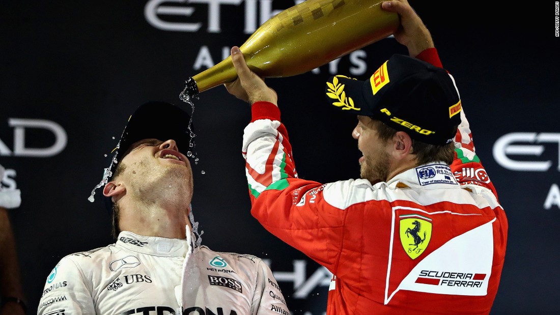 Rosberg is showered with champagne by his compatriot Sebastian Vettel, who was third for Ferrari. 