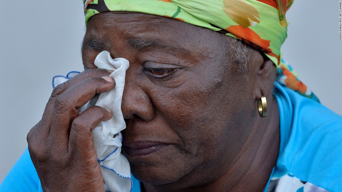 A woman dries her tears as she waits to pay her respects in Havana on November 28.