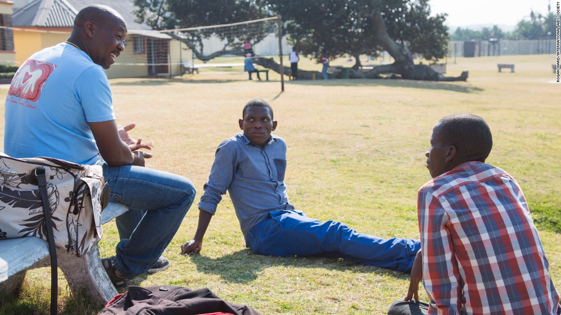 At the Mercury Hibberdene Childrens Camp, teenagers visit once a year from an HIV clinic visit once a year. Sabelo Chonco, center, and Nhlanhla Phewa talk with camp leader Tshepo Tshipe.