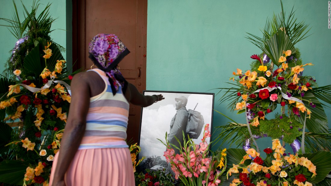 A woman stretches her hand toward a picture of Castro at a memorial in Guanabacoa, on the outskirts of Havana, on November 29.