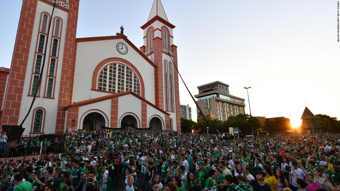 People surround a church during a memorial Mass in Chapeco on November 29.